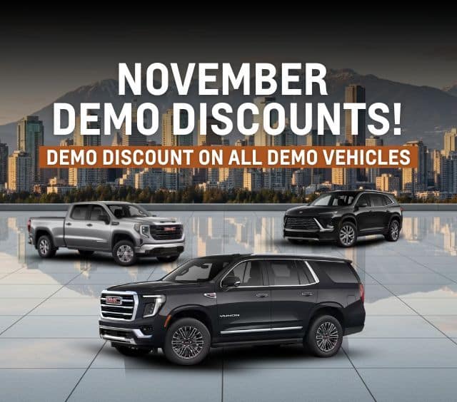 Promotional image highlighting November demo discounts on GMC vehicles, featuring a black GMC Yukon, a silver GMC Sierra truck, and a stylish SUV against a city skyline backdrop.