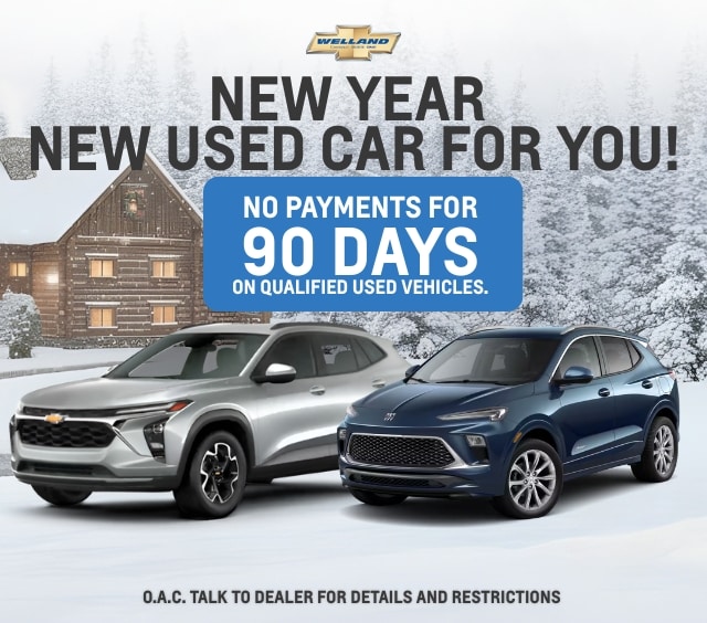 New Year used car sale, no payments for 90 days on qualified vehicles, featuring silver and blue cars.
