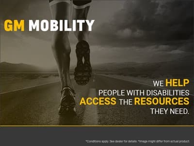 A runner on a road symbolizes freedom and mobility, accompanied by the text "GM Mobility" and a message about helping people with disabilities access essential resources.