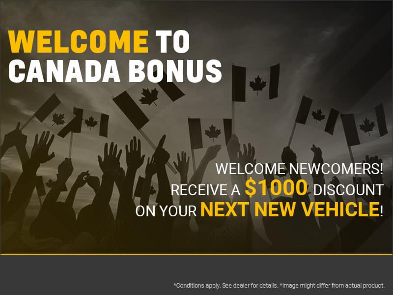 Welcome to Canada Bonus promotional image featuring a diverse group of people raising Canadian flags. The ad invites newcomers to receive a $1,000 discount on their next new vehicle purchase. Brightly colored text emphasizes the discount offer, appealing to new residents.