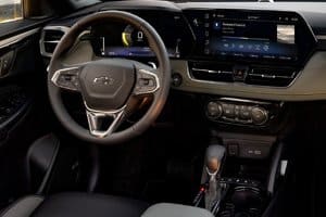 Interior view of a modern Chevrolet car, showcasing the steering wheel, touchscreen display, and control panel with advanced infotainment options, highlighting a sleek and ergonomic design.