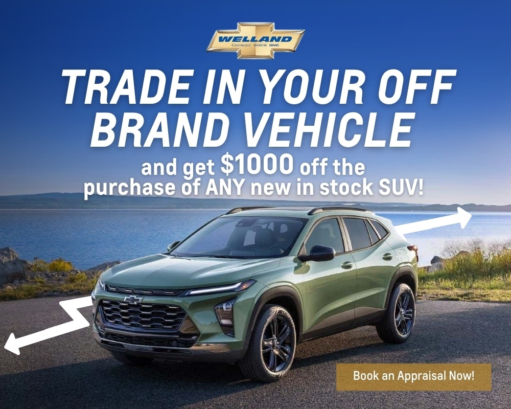 Green SUV parked by a scenic waterfront with promotional text highlighting a trade-in offer for off-brand vehicles, providing a $1000 discount on any new in-stock SUV at Welland Chevrolet Buick GMC.