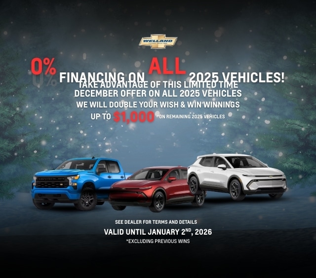Promotional image featuring a Chevrolet dealership advertisement for 0% financing on all 2025 vehicles, highlighting a limited-time December offer. The image displays three vehicles: a blue truck, a red car, and a white SUV, with festive decorations in the background. The text mentions the offer is valid until January 2, 2026, and includes details about doubling winnings up to $1,000 on remaining vehicles.